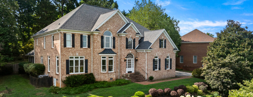 Drone view of spacious larger home exterior under 5,000 sq ft in Knoxville TN – affordable real estate photography header example by PadPics.com